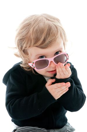 A little girl with her sunglasses on a white backgroundの写真素材