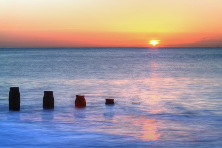 Sun rising above the seaの写真素材