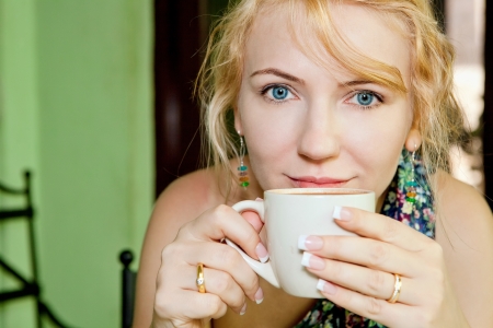 Beautiful woman with a cup of coffeeの写真素材