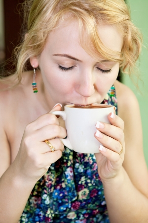 Woman enjoying her cup of chocolate or coffeeの写真素材