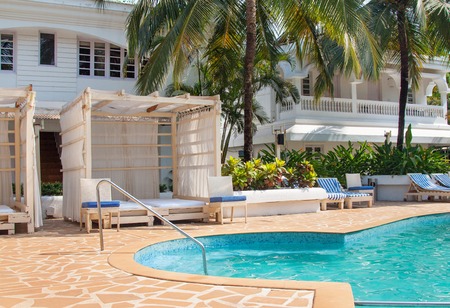 Kolva, India - April 20, 2016: Bright relax travel photo with blue pool and green palmsのeditorial素材