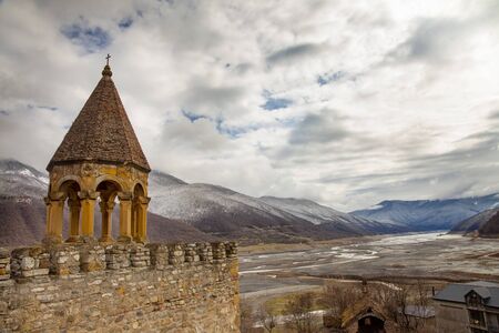 Old Castle Church in Cloudy Mountain Landscape