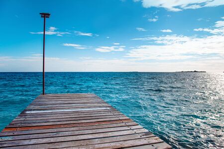 Wooden bridgw way to blue ocean waves