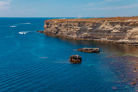 Blue sea lanscape with high stone cliffの写真素材