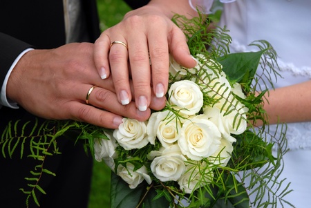 Wedding rings on wedding day,against the background of a wedding bouquet.の写真素材