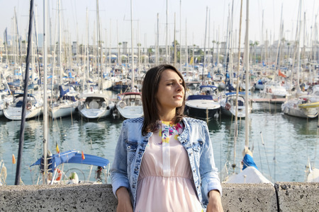 Girl on the background of boatsの写真素材