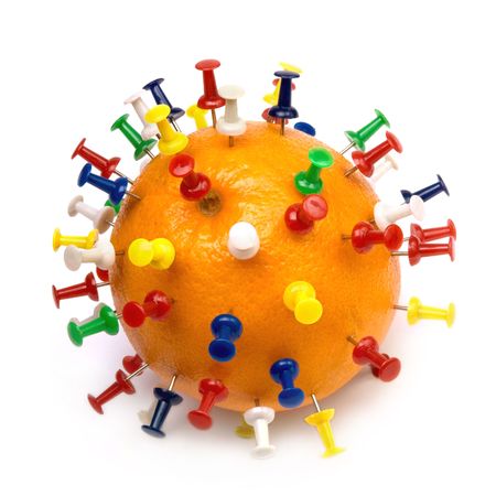 Scratchy orange with colored pinsの写真素材