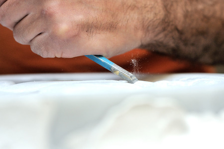 Stone mason at work carving an ornamental reliefの写真素材