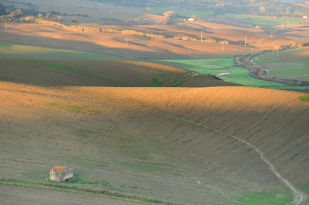 Orange sunrise with house red roof in the italian countryの写真素材