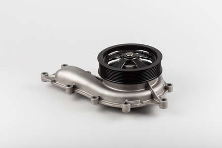 Water pump for truck on gray background. New truck parts. Car spare parts for repair. Pumping....