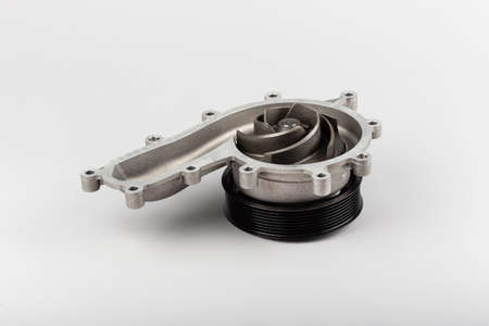 Water pump for truck on gray background. New truck parts. Car spare parts for repair. Pumping....