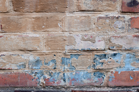 Background of old vintage dirty brick wall with peeling plaster, textureの写真素材
