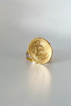 Golden bitcoin. Cryptocurrency on white background. ?rypto  coin standing upright with copy spaceの写真素材
