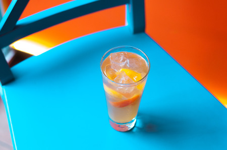 Orange juice on blue wooden background, top view. Closeup glass of cocktailの写真素材