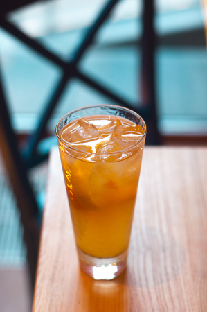 Refreshing citrus lemonade, summer drink. Ice tea with fresh lemon on wooden background. Refreshment beverage concept.の写真素材