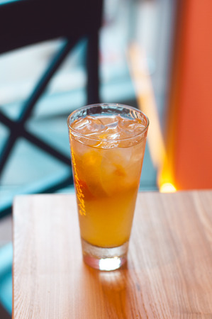 Refreshing citrus lemonade, summer drink. Ice tea with fresh lemon on wooden background. Refreshment beverage concept.の写真素材