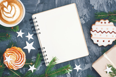 Christmas and New Year background with notepad, cappuccino and decorations. Copy space. Top view. Christmas concept.の写真素材