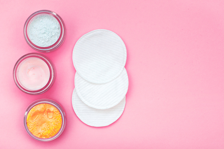 Blue, pink and gold cream in a jar with napkins for face. Mask of clay. Cope space, flat lay, top view.の写真素材