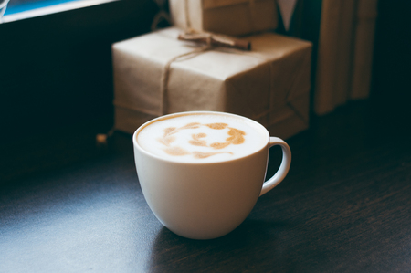 Top view of hot coffee cappuccino latte art in white ceramic cup on marble table. Coffee cup top view on old wooden. Coffee cup in coffee shopの写真素材