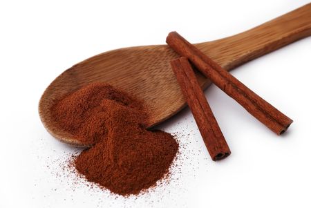 wooden spoon with cinnamon and a few tubes of cinnamonの写真素材