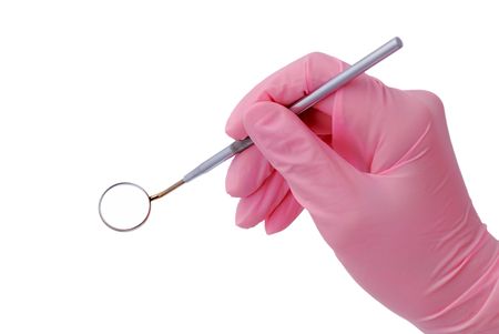 dental mirror in hand with a doctor in a pink gloveの写真素材