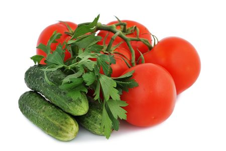 tomatoes, cucumbers and parsley on a white backgroundの写真素材