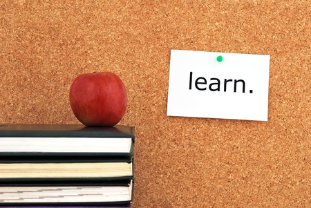 apple and books. against the background of the inscription cork boardの写真素材