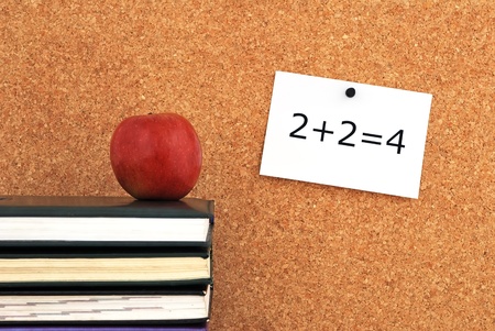 apple and books. against the background of the inscription cork boardの写真素材