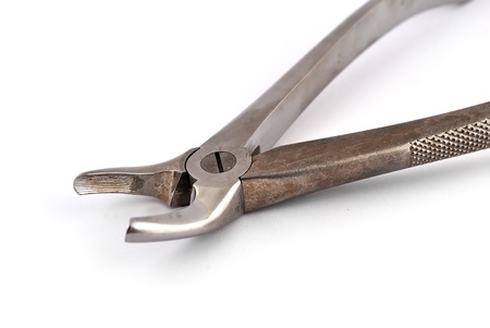 old dental pliers on a white backgroundの写真素材
