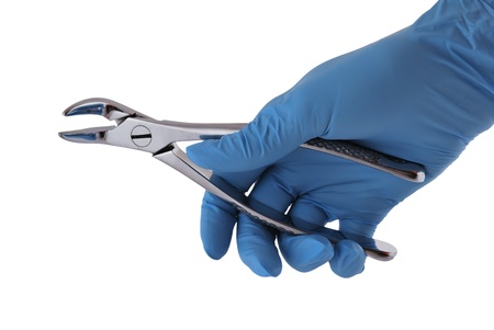 dental forceps in his hand on a white backgroundの写真素材
