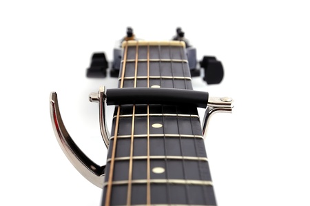 kapodastr jammed on an acoustic guitar on the fourth fretの写真素材