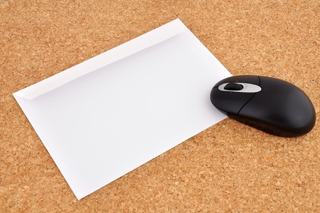 wireless mouse and an envelope on the cork backgroundの写真素材