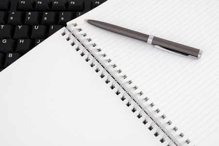 diary with a pen on the keyboardの写真素材