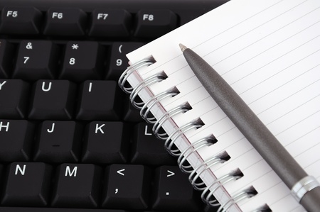 diary with a pen on the keyboardの写真素材