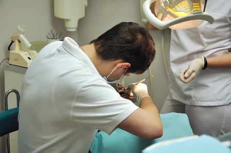 dentist and assistant operate on the patientの写真素材
