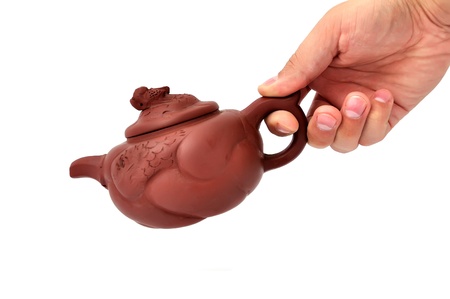 brown ceramic teapot on a white backgroundの写真素材