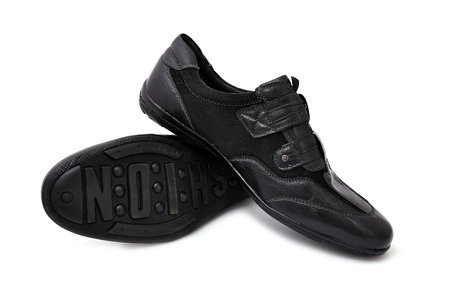 black athletic shoes on white backgroundの写真素材