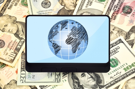digital tablet with planet on background of dollarsの写真素材