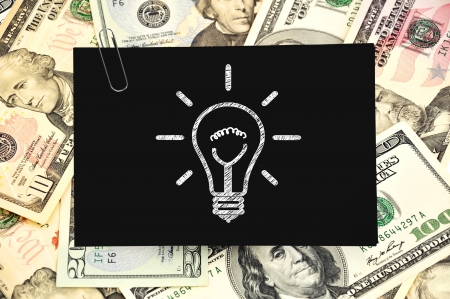 paper with drawing lamp on money backgroundの写真素材