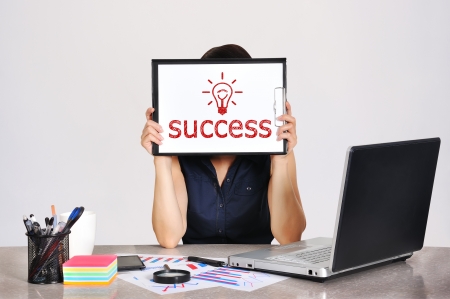 businesswoman holding clipboard with drawing success signの写真素材