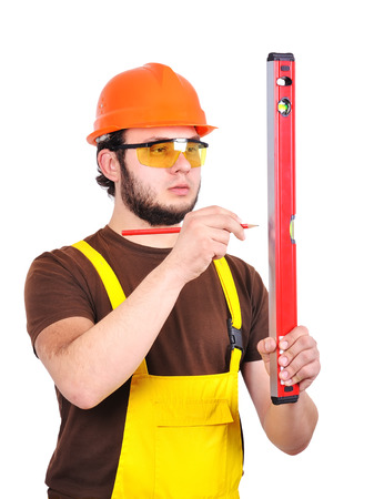 builder holding wasserwaage and pencil  on a white background