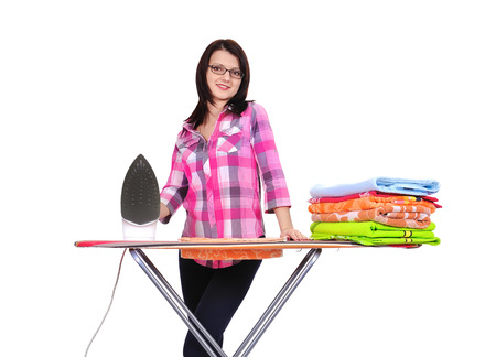 young beautiful woman ironing clothes on a white backgroundの写真素材