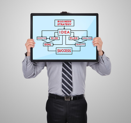 businessman holding a plasma panel with business planの写真素材