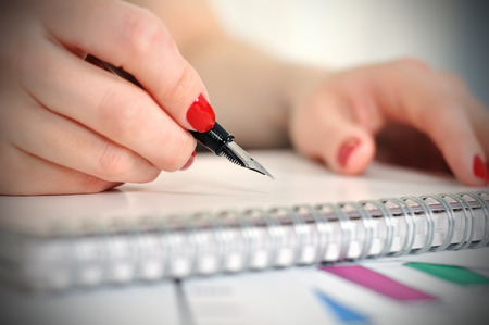 fountain pen writing or signing on a blank diary