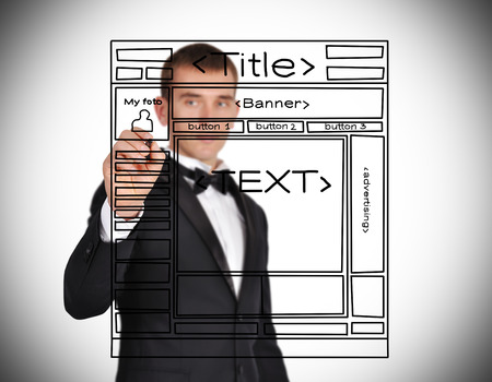 businessman with pen in hand drawing template website