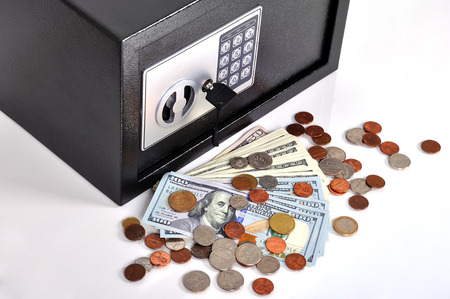 close safe with dollars and cent on a white の写真素材