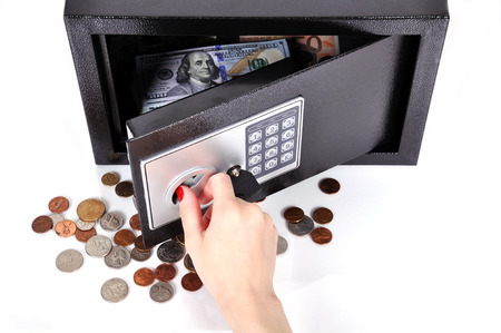 hand opening  safe with dollars and centの写真素材