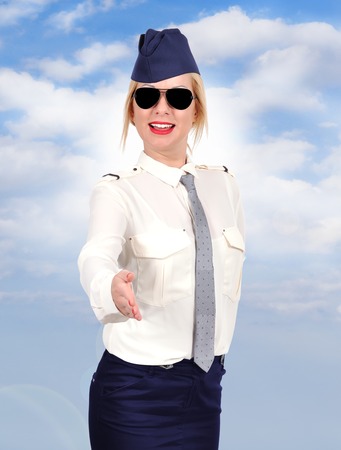Flight attendant welcomes passengers on boardの写真素材