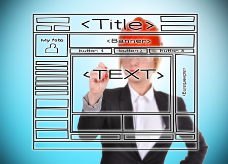 Engineer woman drawing template website on a blue backgroundの写真素材