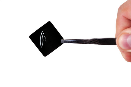 hand holding black rfid tag on tweezers